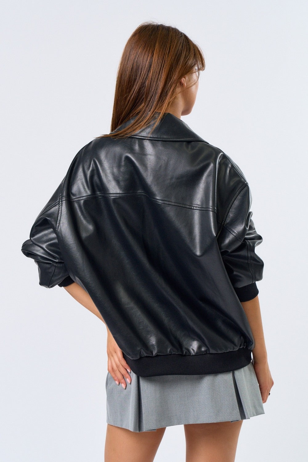 Person wearing a black leather jacket on a white background