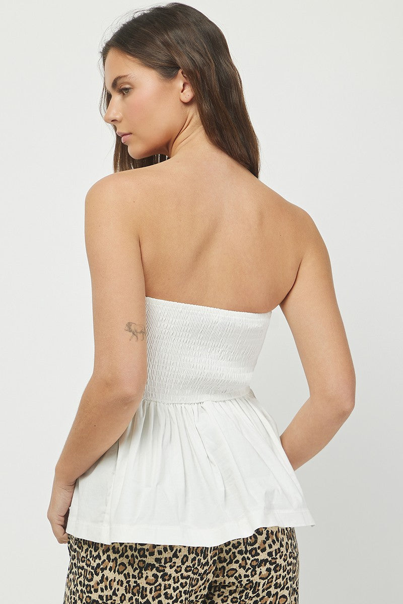 Upgrade your wardrobe with this chic white strapless peplum top, designed to add a touch of elegance to any outfit. Featuring a ruched bustier-style bodice for a flattering fit and a flowy peplum hem, this top is perfect for day-to-night styling. Pair it with denim, trousers, or skirts for a sophisticated yet effortless look. Whether you're heading to a brunch date, tropical getaway, or rooftop party, this versatile blouse is your go-to for timeless fashion.
