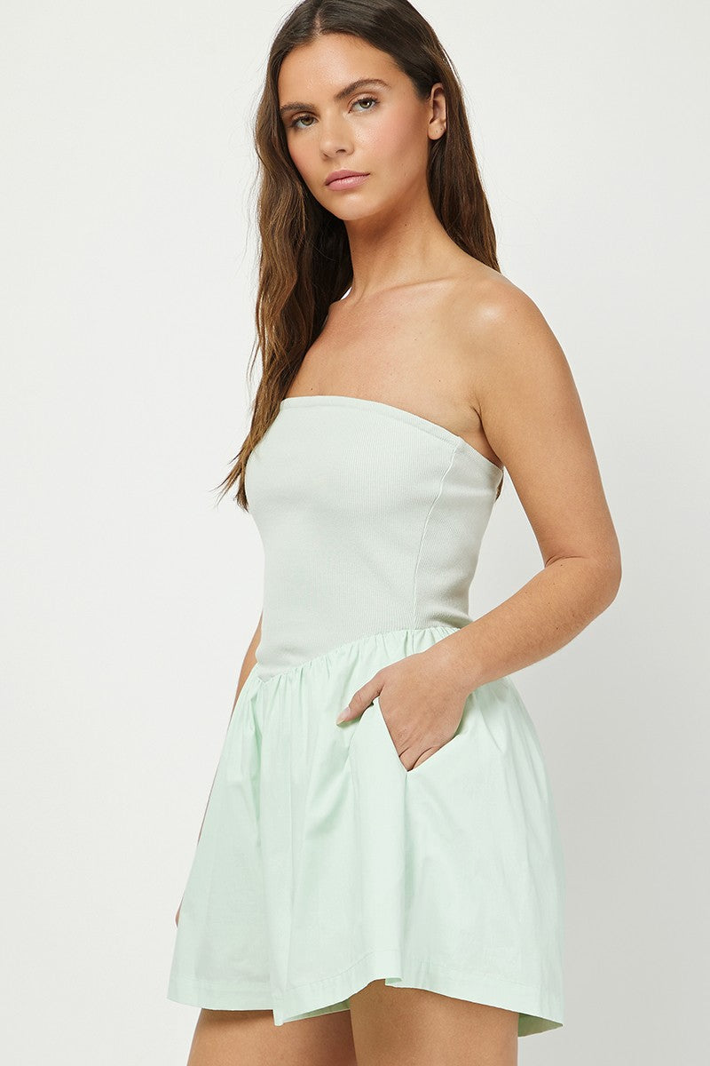Women's mint green strapless romper featuring a ribbed fitted bodice and a flowy, gathered cotton bottom for a chic and comfortable summer look.