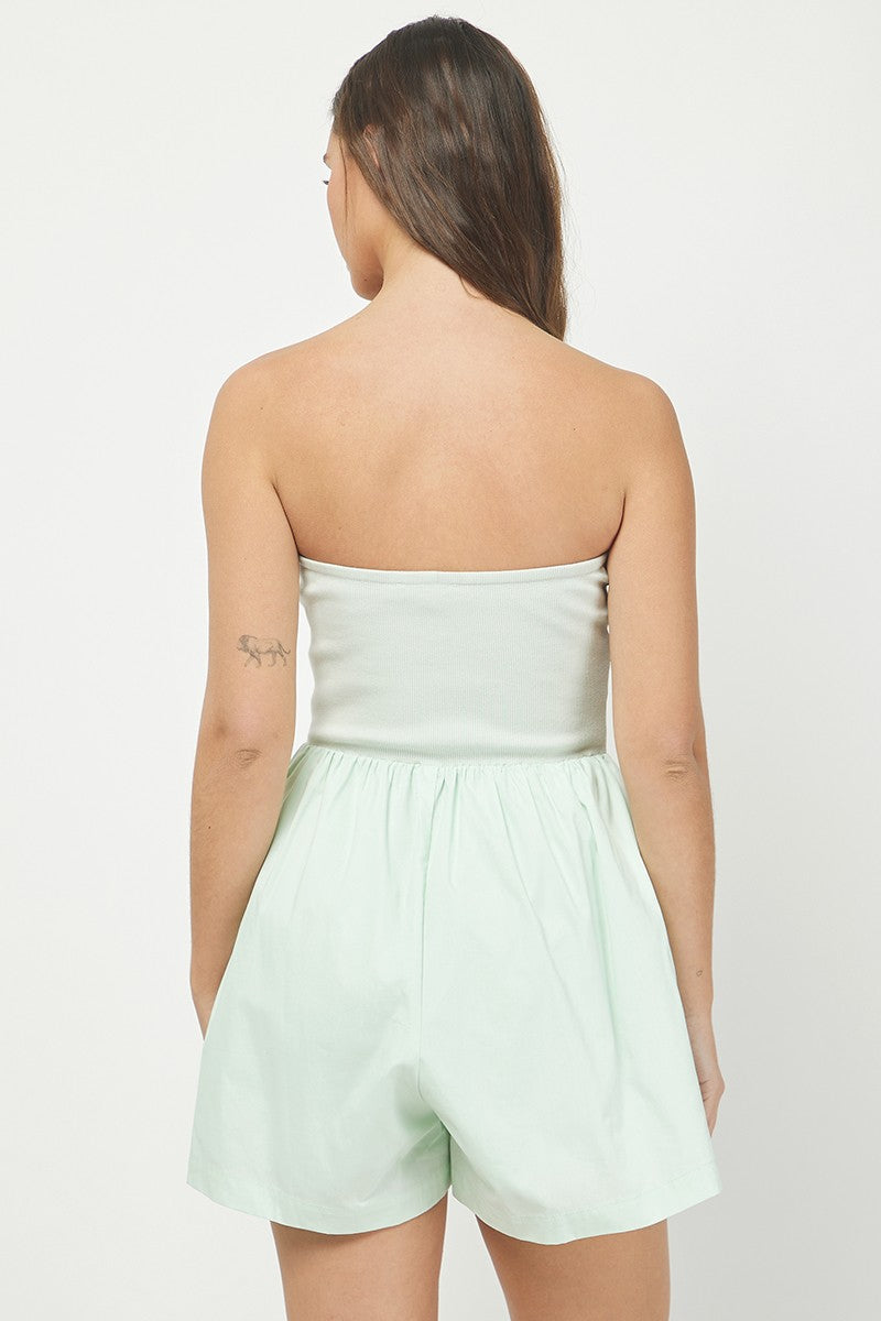 Women's mint green strapless romper featuring a ribbed fitted bodice and a flowy, gathered cotton bottom for a chic and comfortable summer look.