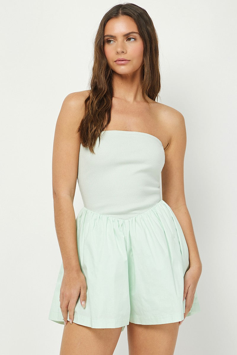 Women's mint green strapless romper featuring a ribbed fitted bodice and a flowy, gathered cotton bottom for a chic and comfortable summer look.