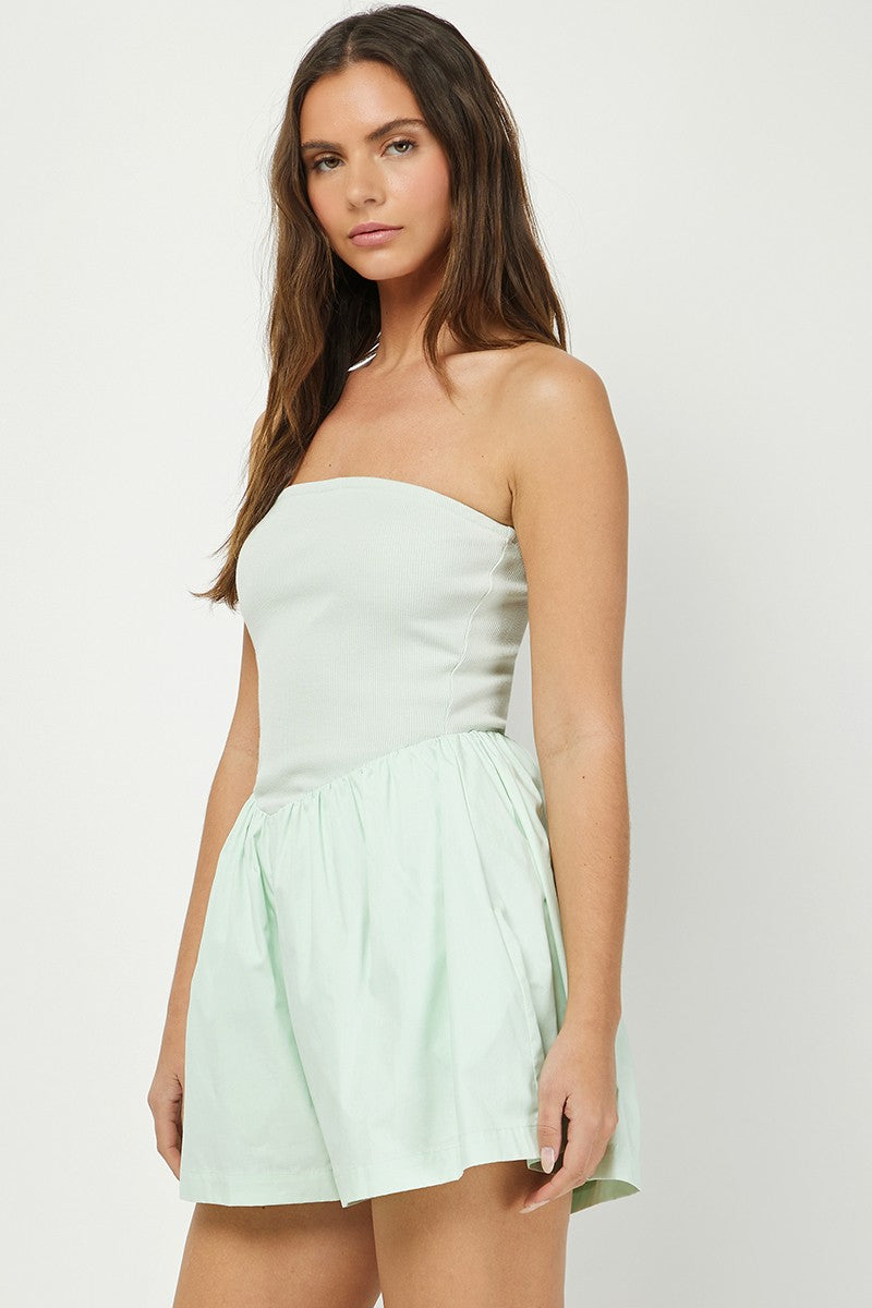 Women's mint green strapless romper featuring a ribbed fitted bodice and a flowy, gathered cotton bottom for a chic and comfortable summer look.