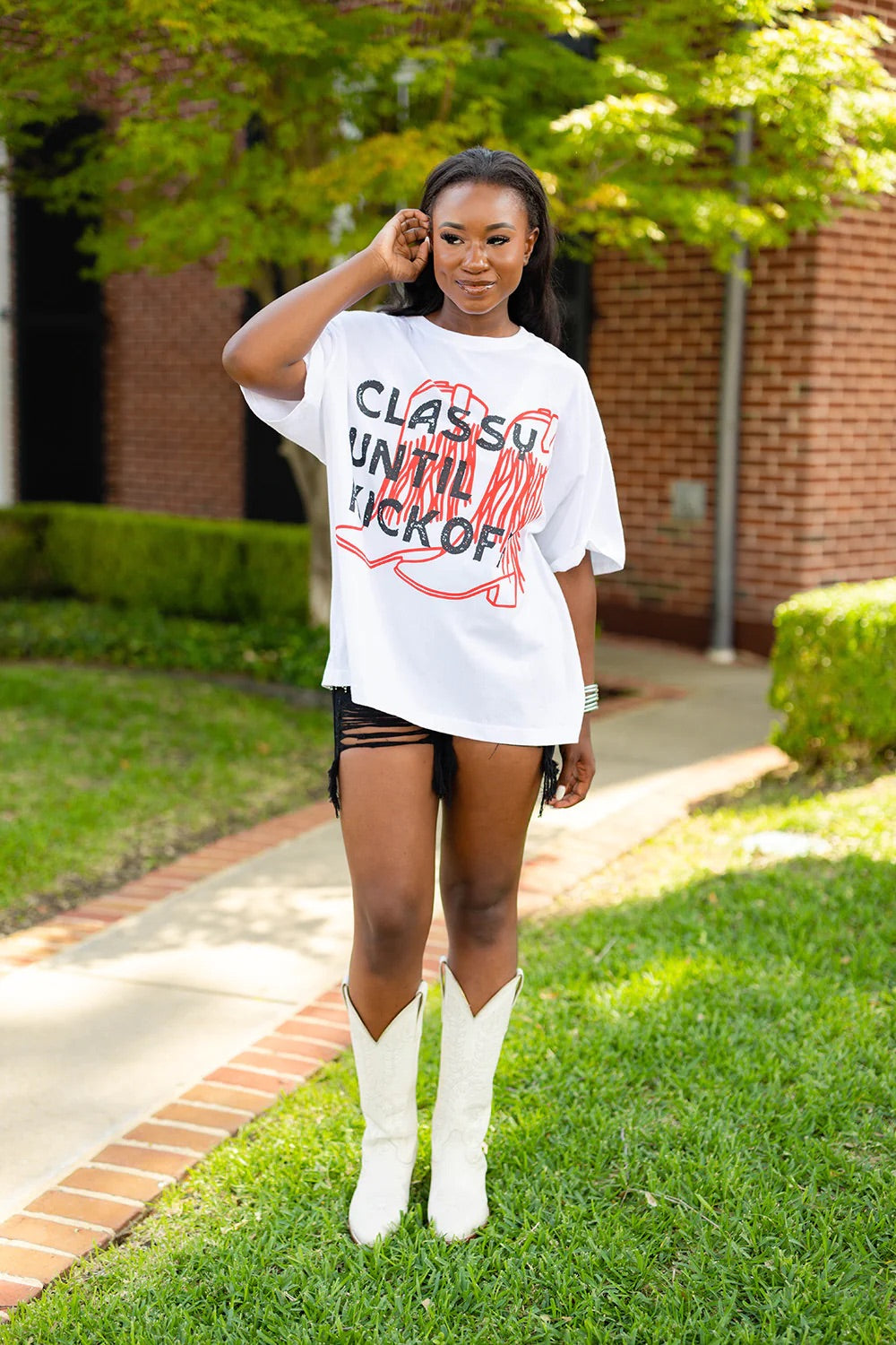 Oversized white t shirt with "classy until kickoff" on the front