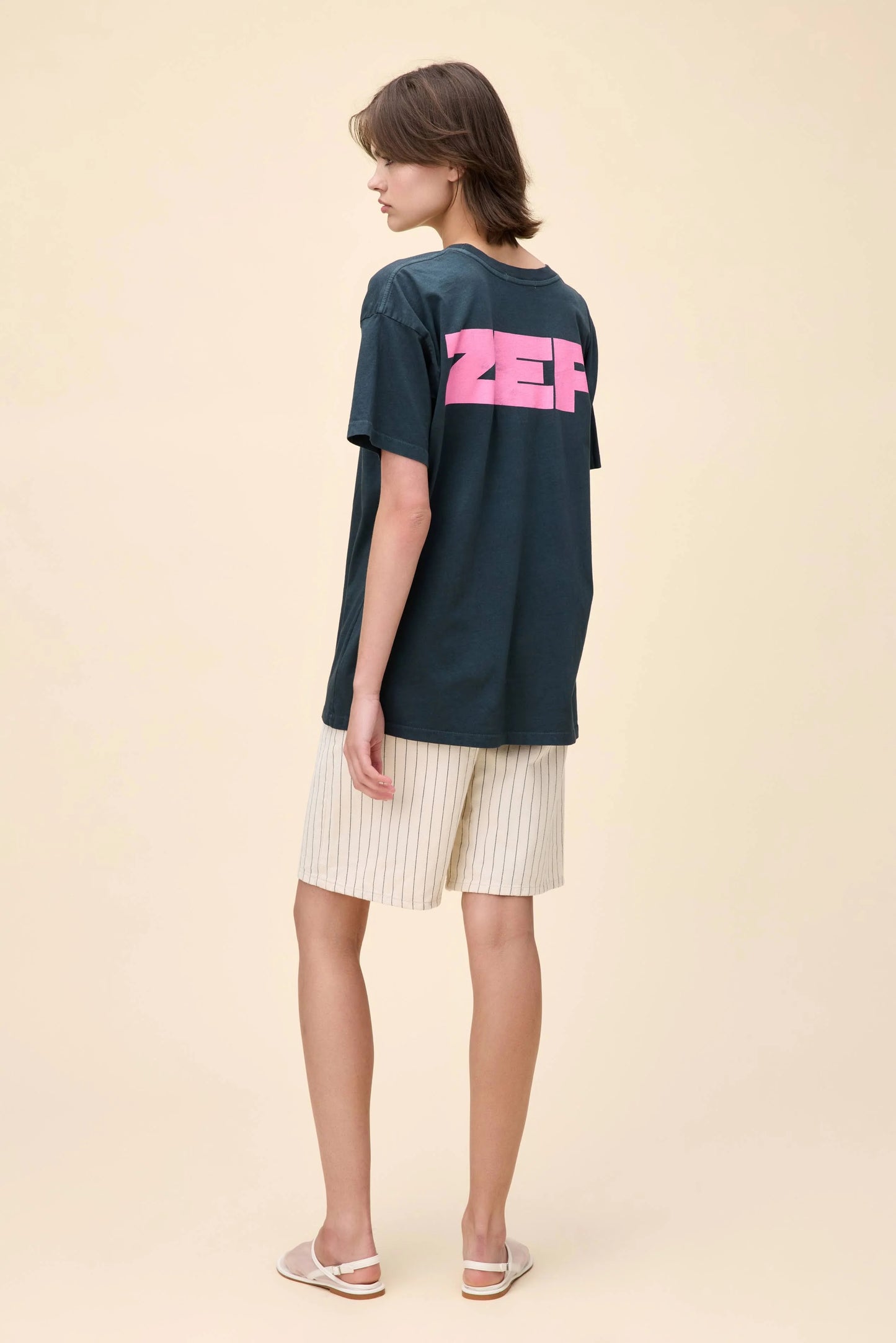 Model showcasing the back of the Led Zeppelin tee with bold "ZEP" text in pink, completing the full "LED ZEP" design.