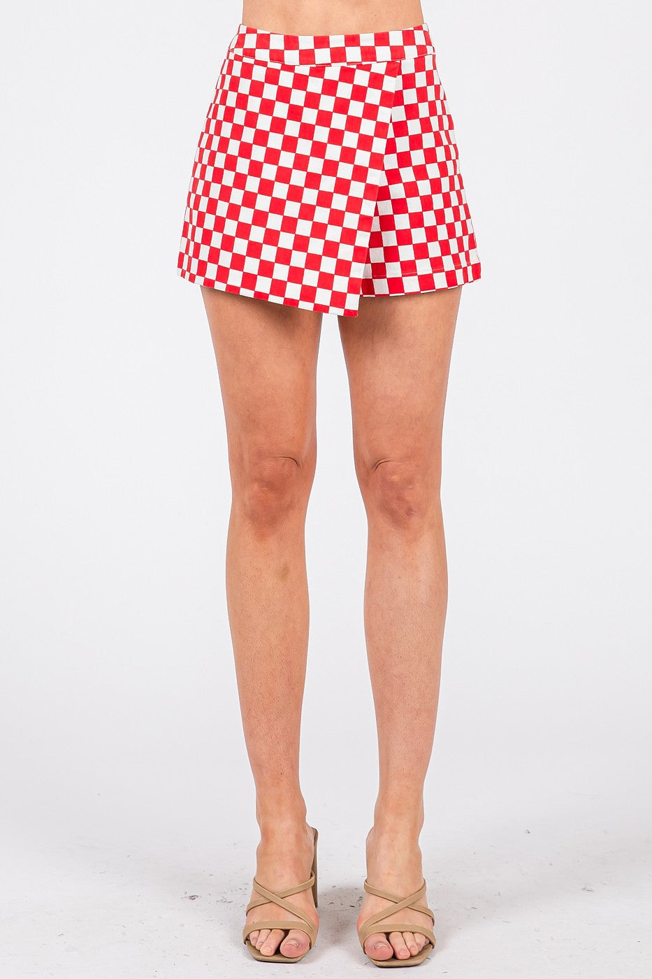 Red and white checkered skirt worn by a person on a white background