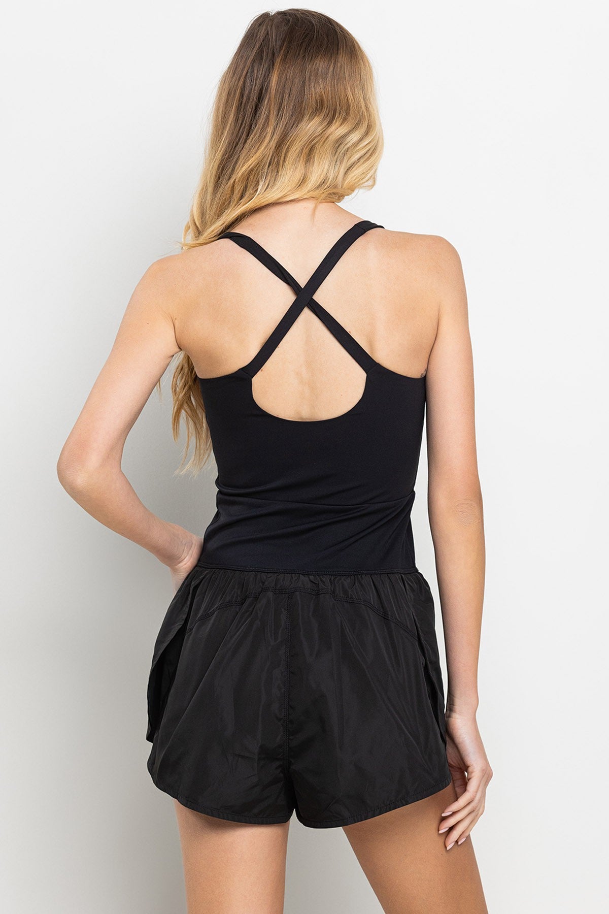 Black romper with elastic waistband, and small center cutout detail. 