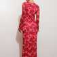 Woman wearing a pink floral dress against a white background