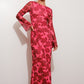 Woman wearing a pink floral dress on a white background