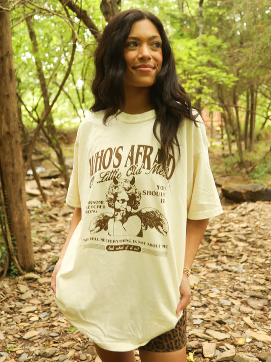 Woman wearing a graphic t-shirt in a forest setting
