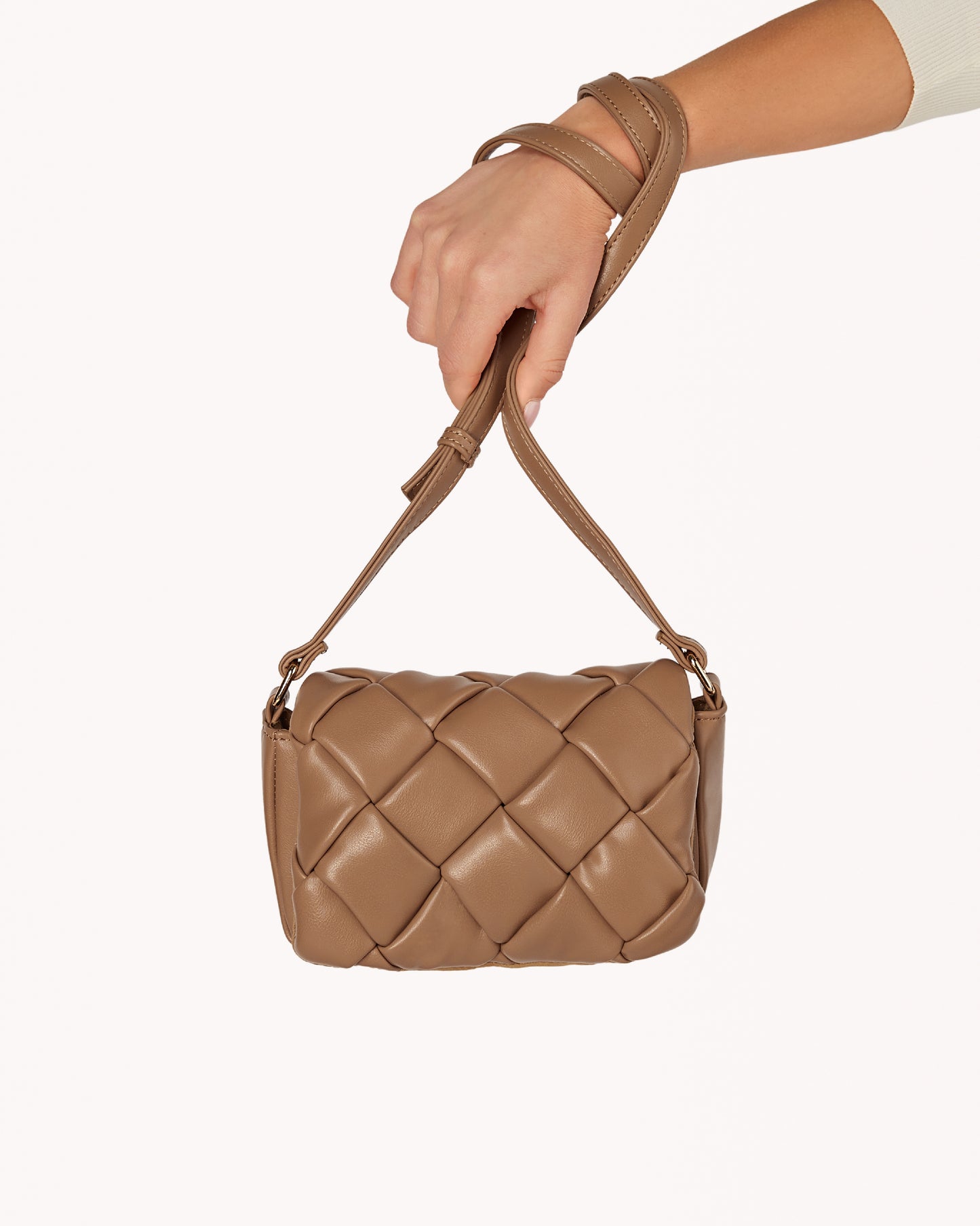 Tan quilted purse with an adjustable crossbody strap