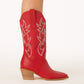Red women’s cowboy boots, they are a mid calf boot with off white western stitching and a tan heel