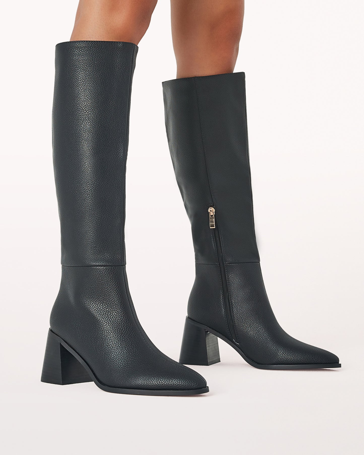 Tall black faux leather boot with a block heel