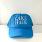 Aqua blue trucker hat with "Lake Hair" embroidered on the front