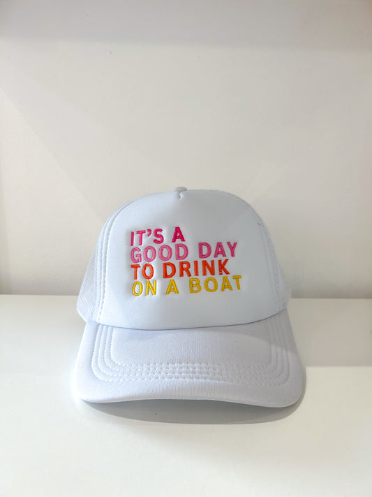 White trucker hat with "It's a good day to drink on a boat" embroidered on the front