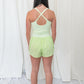 Lime green romper with elastic waistband, and small center cutout detail. 