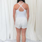 White romper with elastic waistband, and small center cutout detail. 