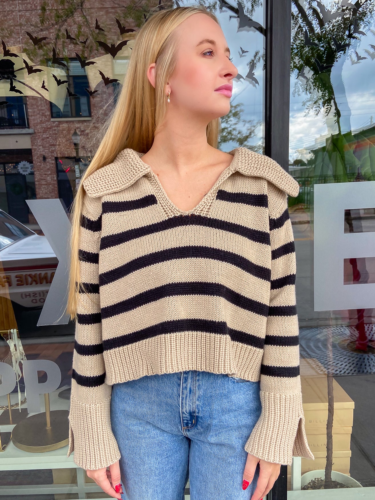 tan and black striped, knitted sweater with a v neck and flat open collar