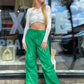 Kelly green wide leg parachute pants. They have a relaxed fit along with an adjustable waistband.