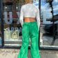 Kelly green wide leg parachute pants. They have a relaxed fit along with an adjustable waistband.