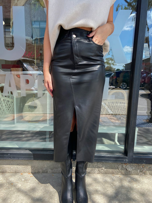 Faux leather black midi skirt with front slit and assemetrical waistband. 