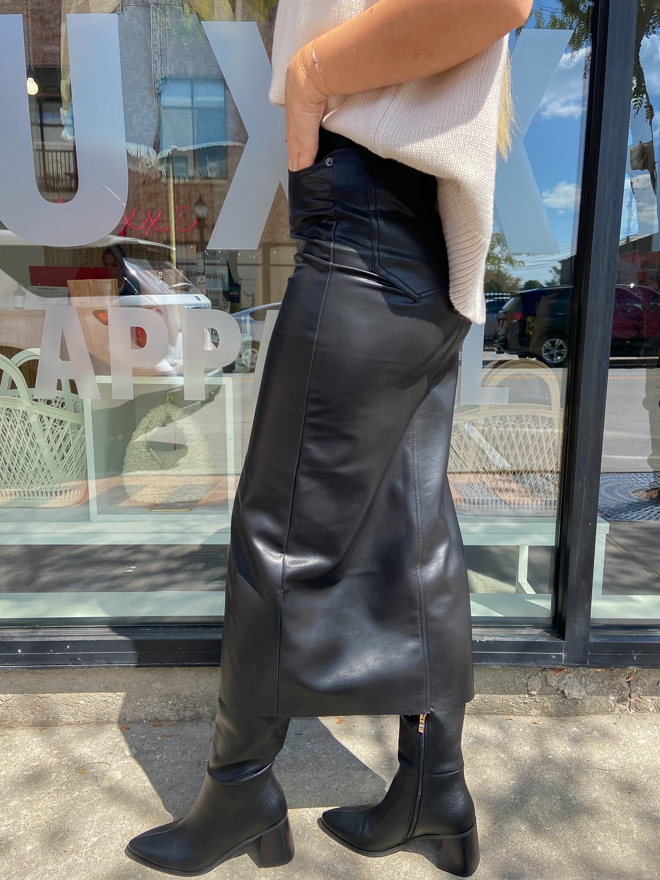Faux leather black midi skirt with front slit and assemetrical waistband. 