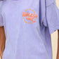 Vintage-inspired Fleetwood Mac Rumours Tour T-shirt in a soft, faded lavender wash, featuring a retro band logo and star graphic on the front. The back showcases 1977-1978 tour dates and locations, with bold lettering and a nostalgic rock aesthetic. Designed in an oversized, relaxed fit, this tee is perfect for music lovers and casual streetwear styling.
