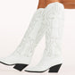 Chic and bold, these white western knee-high boots feature classic cowboy stitching with silver stud embellishments, a pointed toe, and a stacked angled heel. Perfect for country concerts, bachelorette parties, festivals, or trendy street style looks.