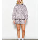 Person wearing a gray tie-dye hoodie and shorts set against a white background