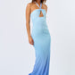 Woman wearing a blue ombré halter maxi dress with front cutout, standing against a plain white background.
