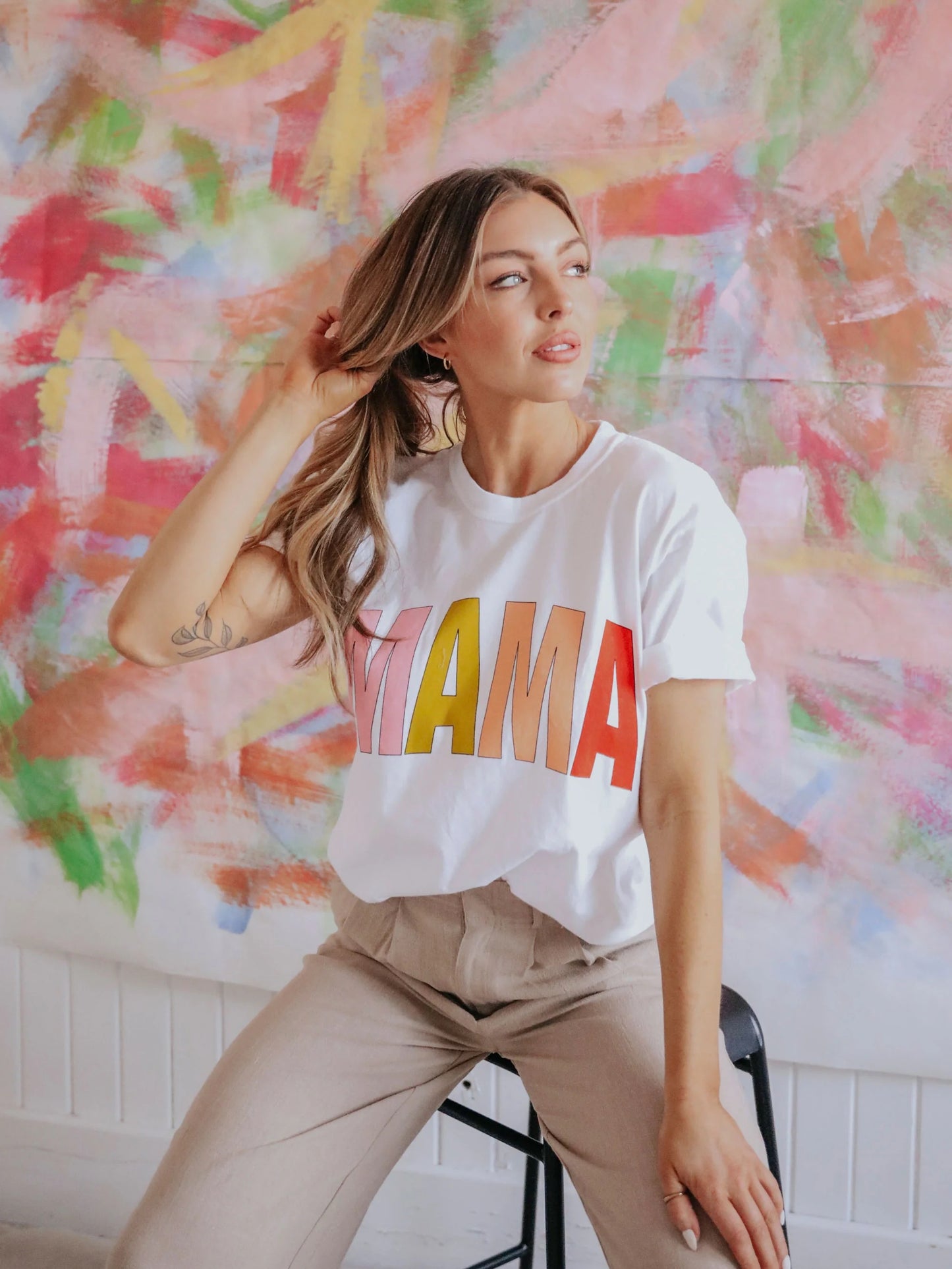 white t-shirt with MAMA in block multi colored letters