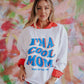 white corded sweatshirt with "im a cool mom most of the time" on the front