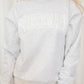 Heather grey crewneck sweatshirt with "Bridesmaid" written in white puff lettering