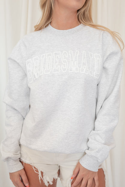 Heather grey crewneck sweatshirt with "Bridesmaid" written in white puff lettering
