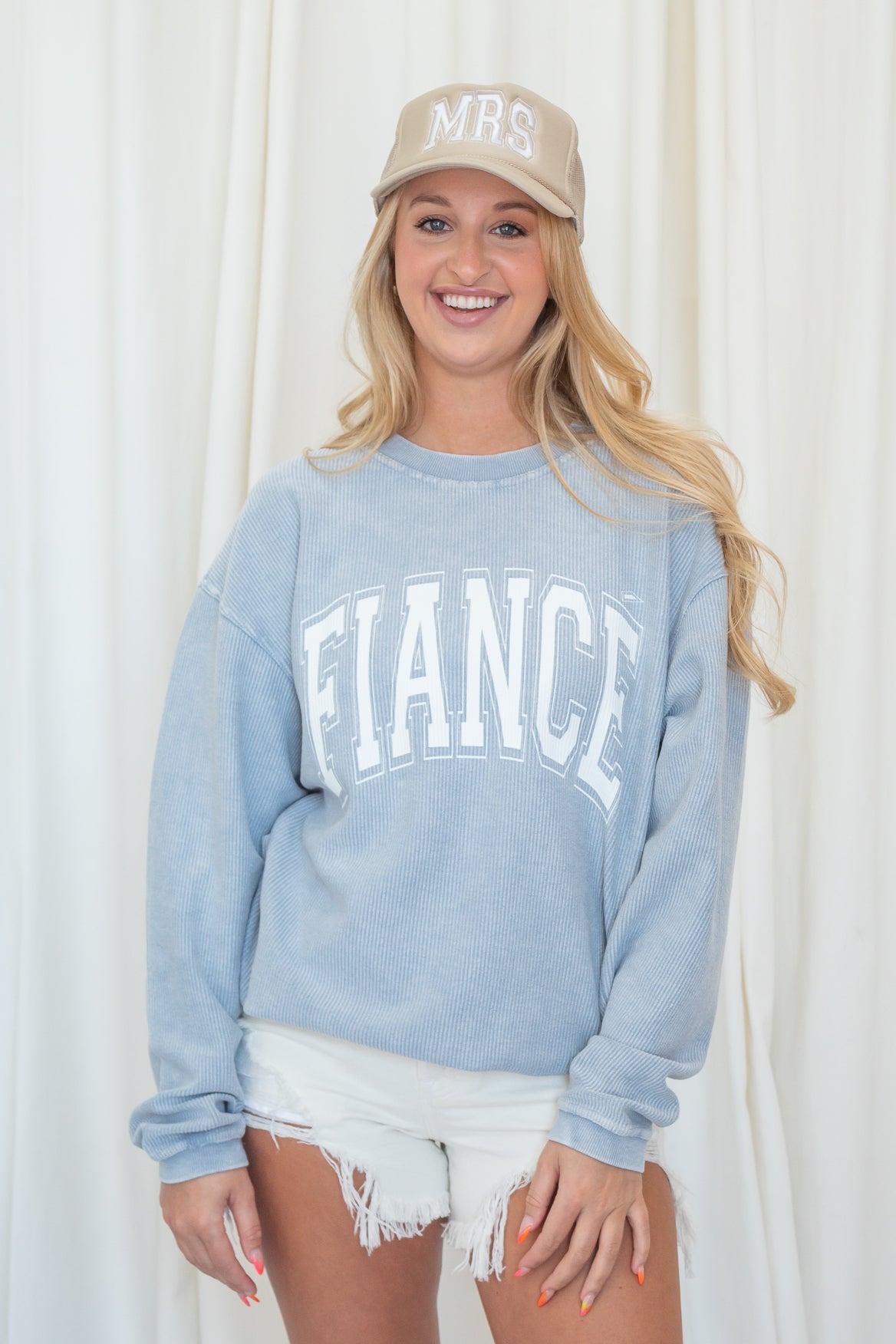 Blue corded sweatshirt with Fiancé  written in white lettering