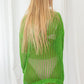 Knitted sheer green oversized top with fringe on the hem and at the cuffs